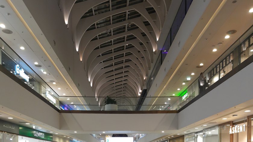 Bright mall corridor with retail storefronts