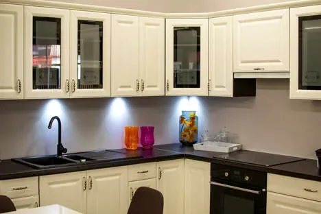 Bull Interiors fitted kitchen with light cabinetry and dark countertop